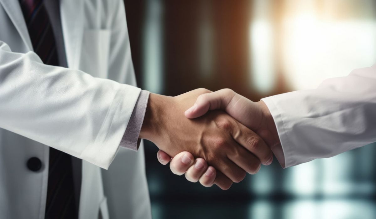 Two professionals shaking hands representing a medical director agreement for a med spa
